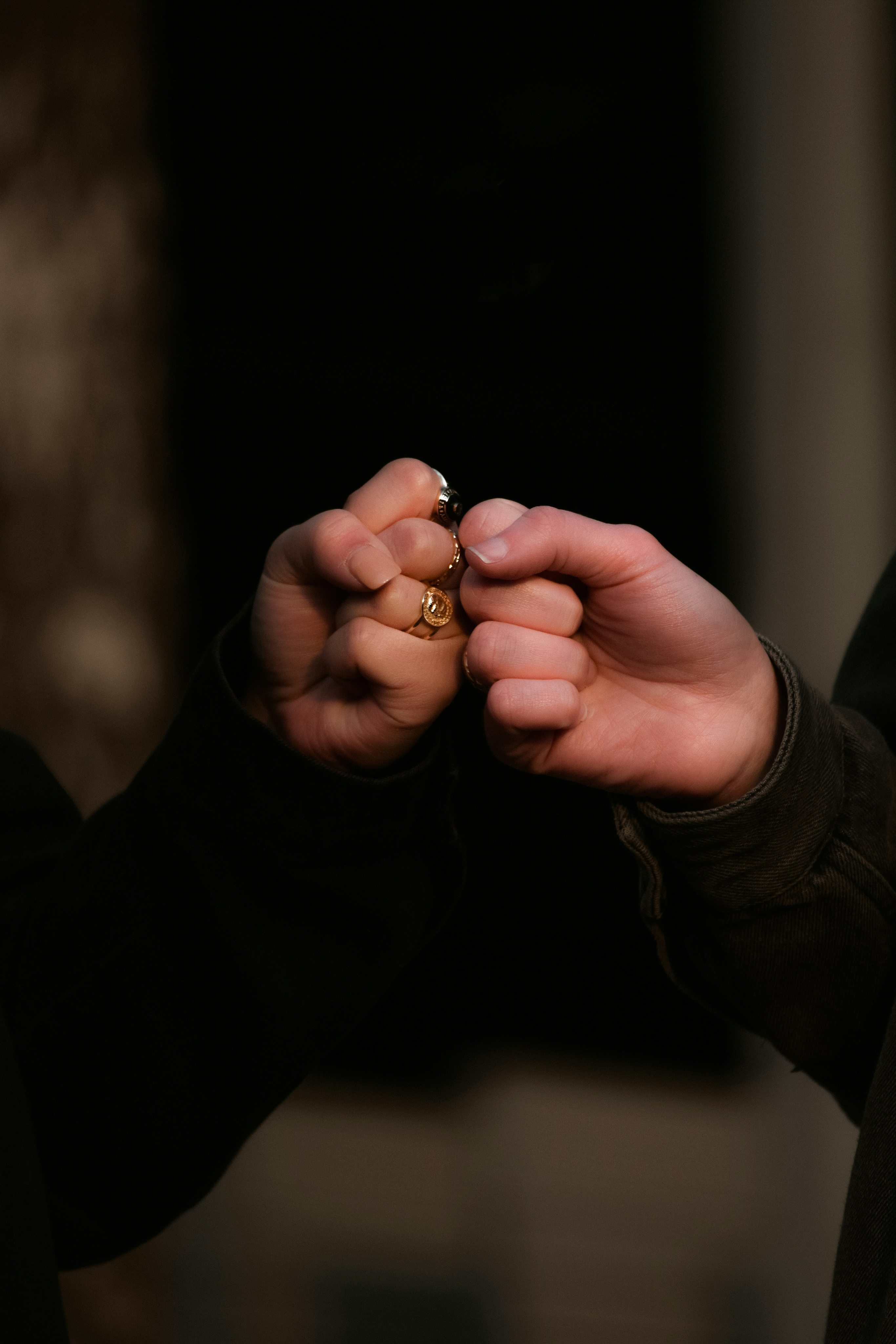 Close up of married couple's hands giving knuckles.